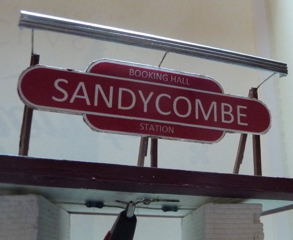 Station sign sandycombe unlit.jpg